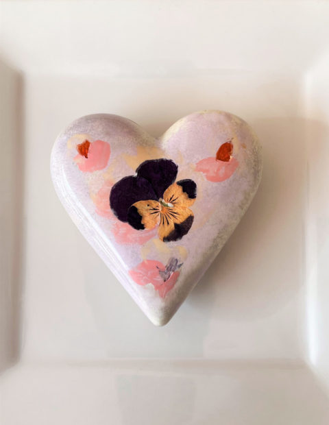Dark chocolate heart with pressed edible flower decoration