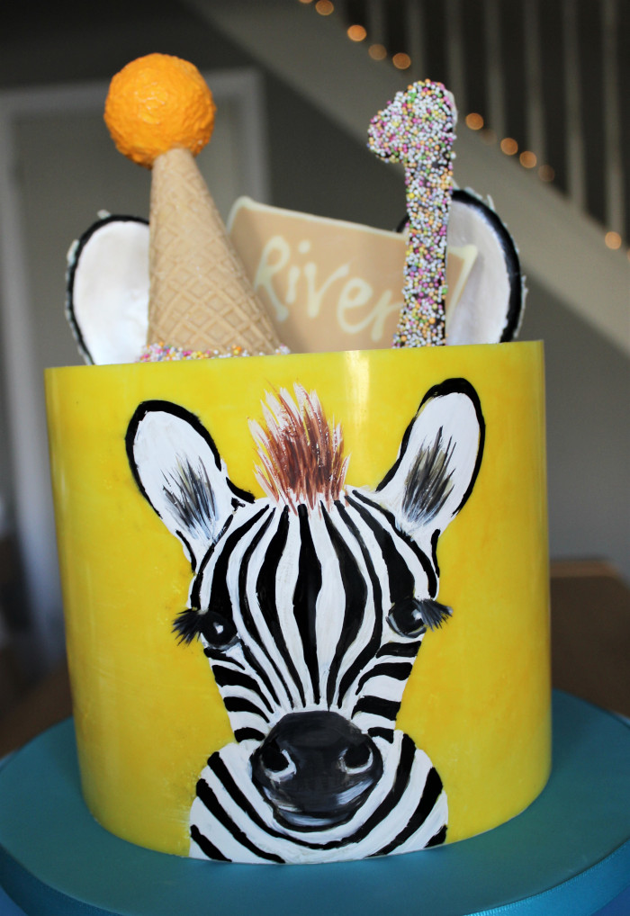 Zebra painted birthday cake with chocolate cone hat and ears