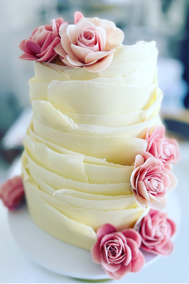 White chocolate wraps wedding cake with pink chocolate roses